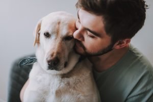 Owner hugging his old dog